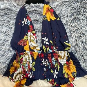 Two piece floral shorts and open back, cropped tie top.